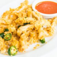 Calamari squid in white plate with spicy sauce