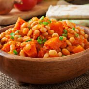 Stewed white beans and sliced pumpkin in tomato sauce